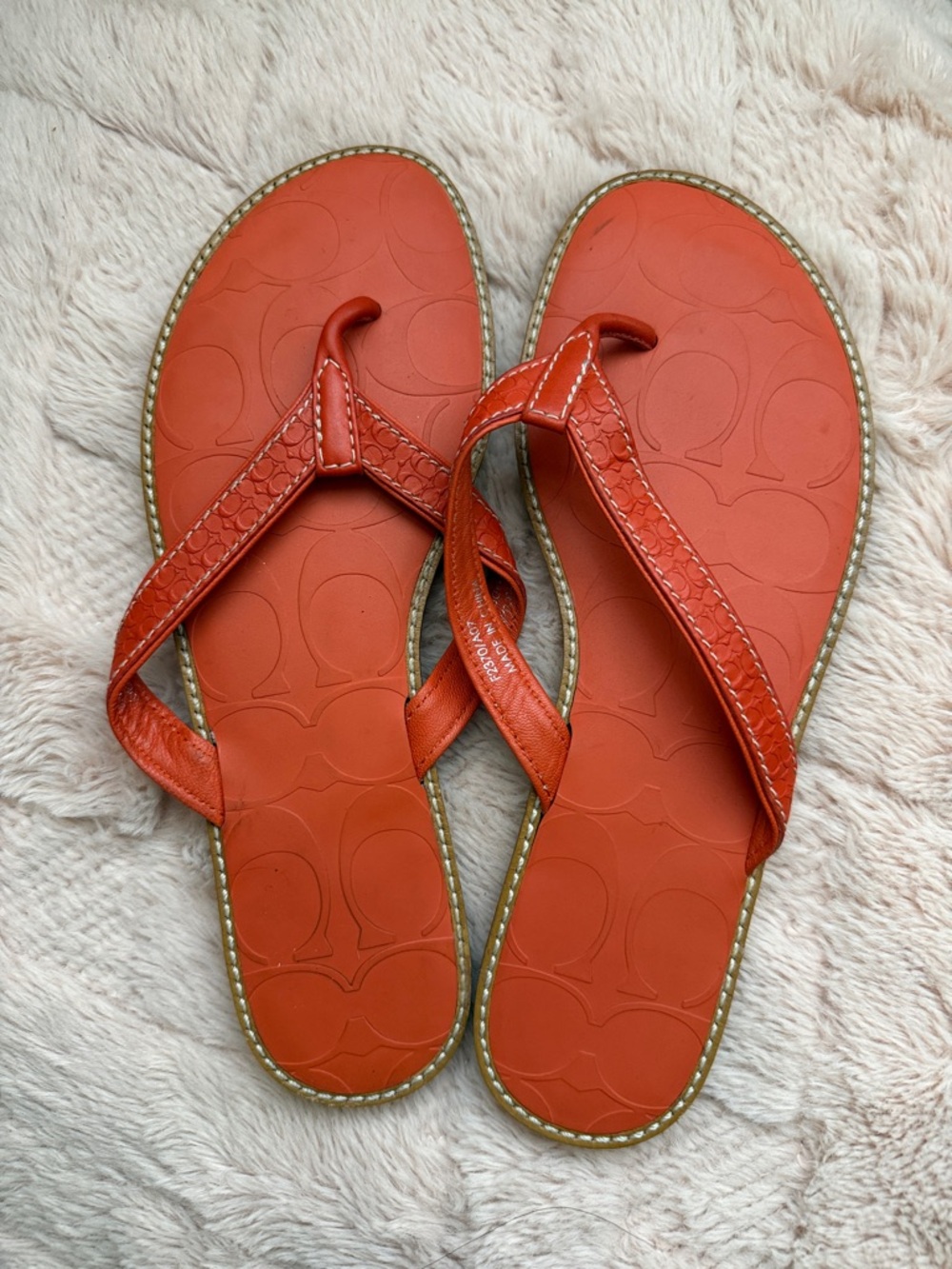 Orange coach flip flops